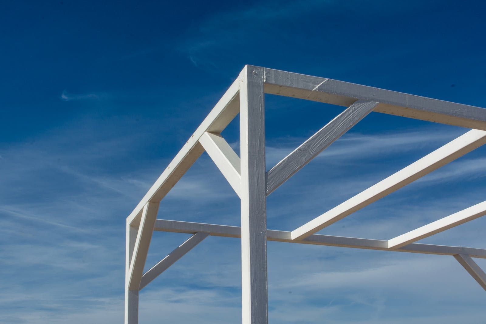 A white wooden structure with a blue sky in the background