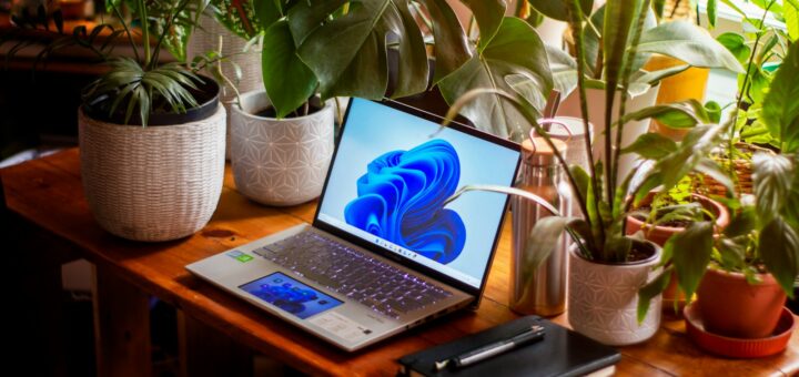 a laptop computer sitting on top of a wooden table