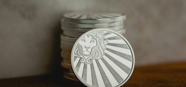 a stack of coins sitting on top of a wooden table