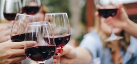 people tossing their clear wine glasses